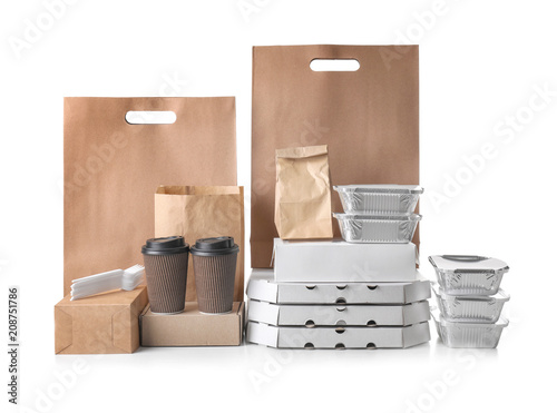 Different types of packages on white background. Food delivery service photo