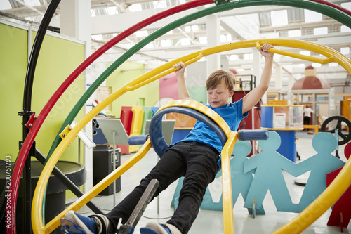 Young white boy in science centre using human gyroscope photo