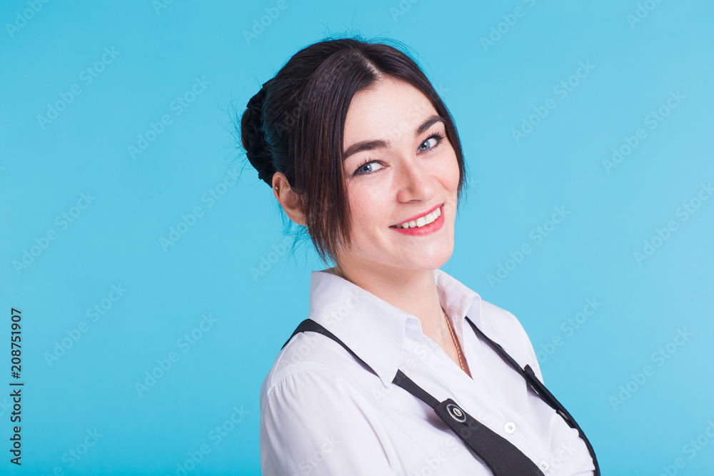 A pretty teenage brunette girl on blue background A pretty teenage brunette girl on blue background