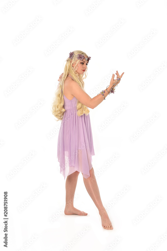 full length portrait of pretty blonde girl wearing purple fairy dress. standing pose, isolated on white studio background. full length portrait of pretty blonde girl wearing purple fairy dress. standing pose, isolated on white studio background.