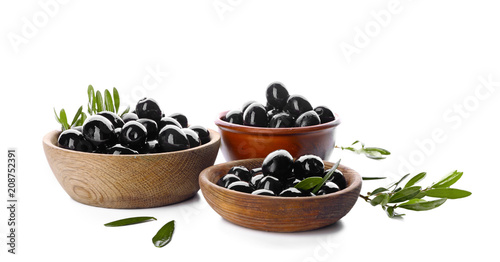 Bowls with black olives on white background