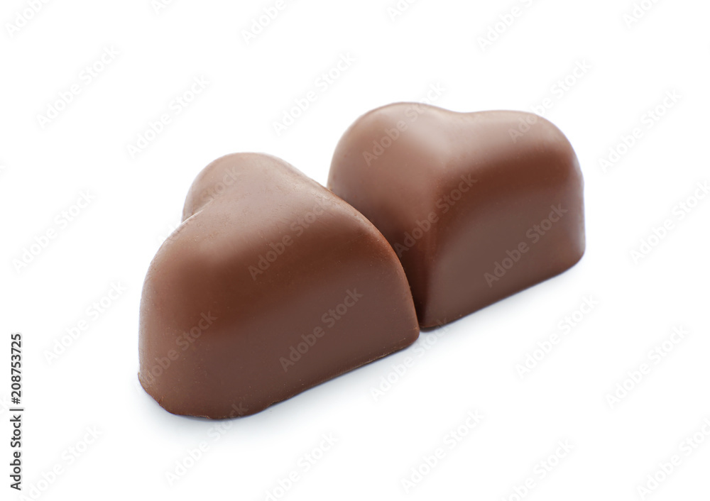 Fototapeta premium Tasty heart-shaped chocolate candies on white background