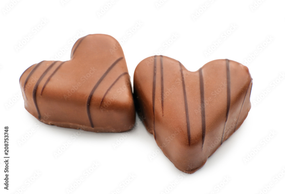 Tasty heart-shaped chocolate candies on white background Tasty heart-shaped chocolate candies on white background