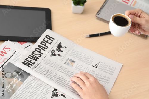Woman reading morning newsp...