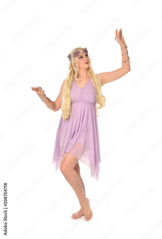 full length portrait of pretty blonde girl wearing purple fairy dress. standing pose, isolated on white studio background. full length portrait of pretty blonde girl wearing purple fairy dress. standing pose, isolated on white studio background.