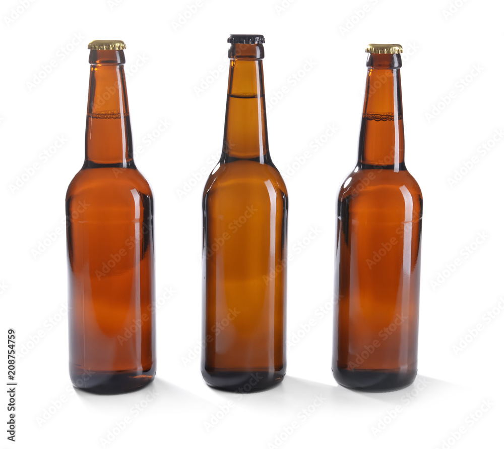 Glass bottles of beer on white background