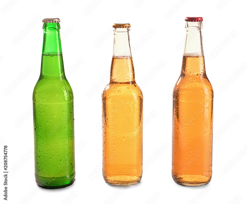 Glass bottles of beer on white background
