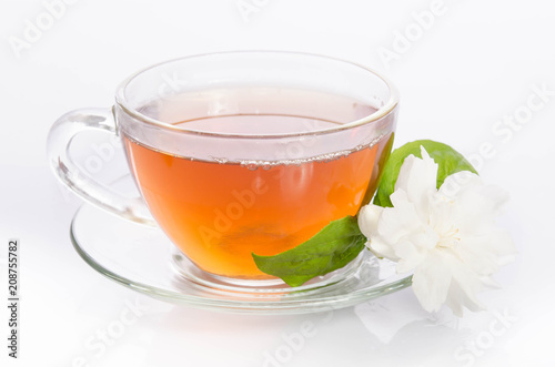 Glass cup of Tea with jasmine flowers and leaves