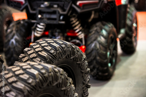 Bild auf Leinwand Tires for quad bike with blurry quad bike(four wheeler, quadricycle or all-terra