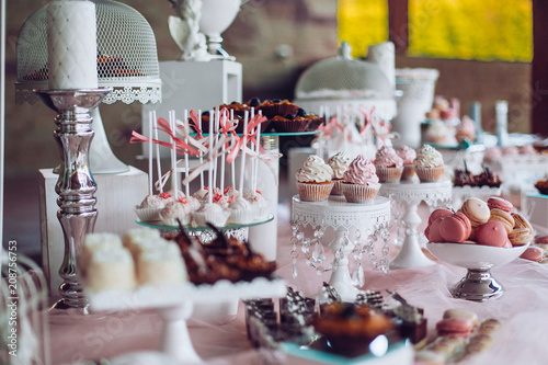 Obraz na płótnie Delicious sweets on candy buffet. Wedding candy bar with a lot of colorful macaroons and another desserts. Wedding party candy bar. w salonie