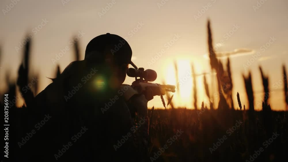 A sniper rifles from a rifle with an optical sight. On the Sunset. Sports shooting and hunting concept