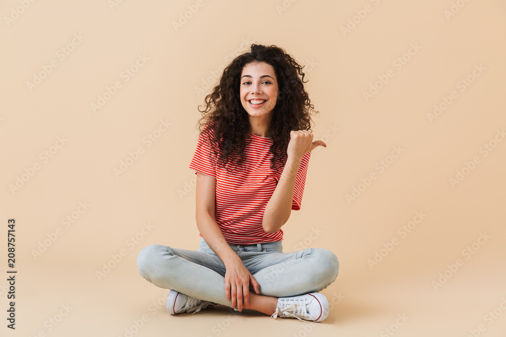 Emotional young woman isolated over beige wall Emotional young woman isolated over beige wall