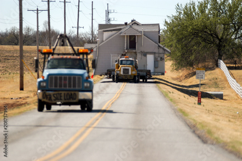 Oversize load - structural house mover with two-storey home on highway