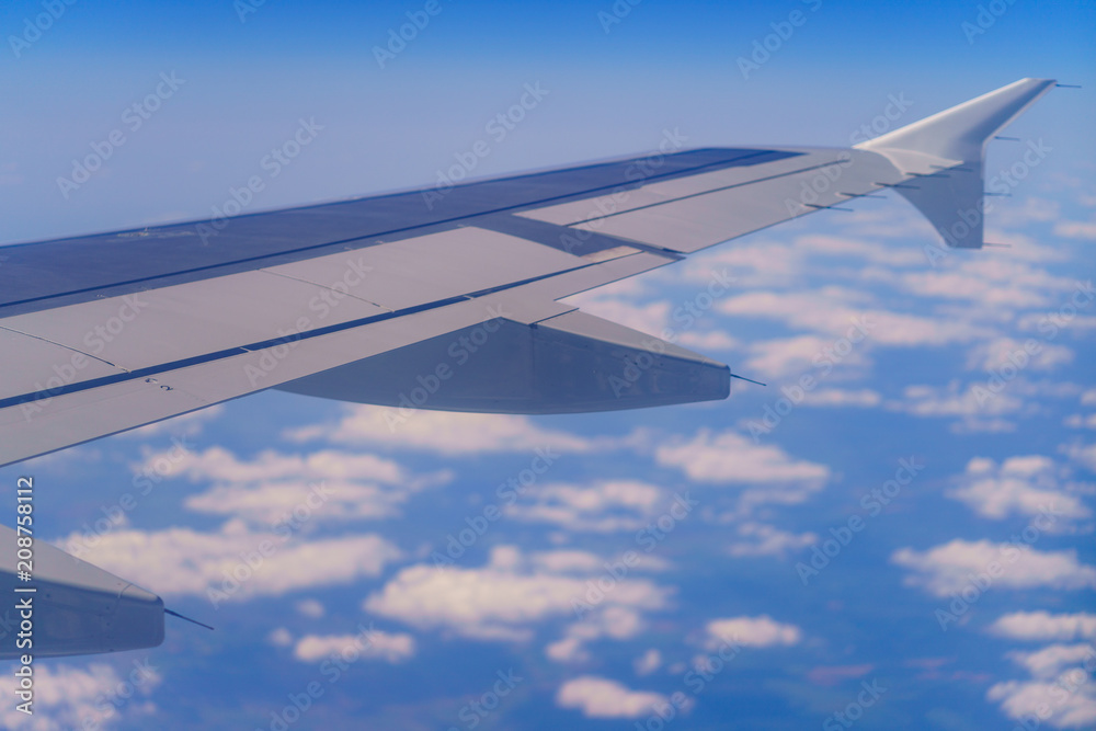Wing of aircraft over the clouds Wing of aircraft over the clouds