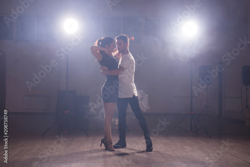 Young couple dancing latin dance Bachata  merengue  salsa. Two elegance pose in dance class