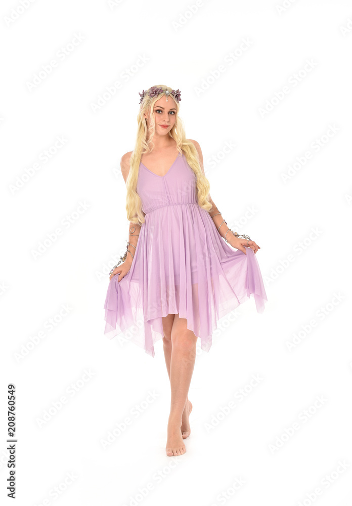 full length portrait of pretty blonde girl wearing purple fairy dress. standing pose, isolated on white studio background. full length portrait of pretty blonde girl wearing purple fairy dress. standing pose, isolated on white studio background.