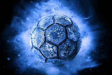 Old Soccer ball in on blue background
