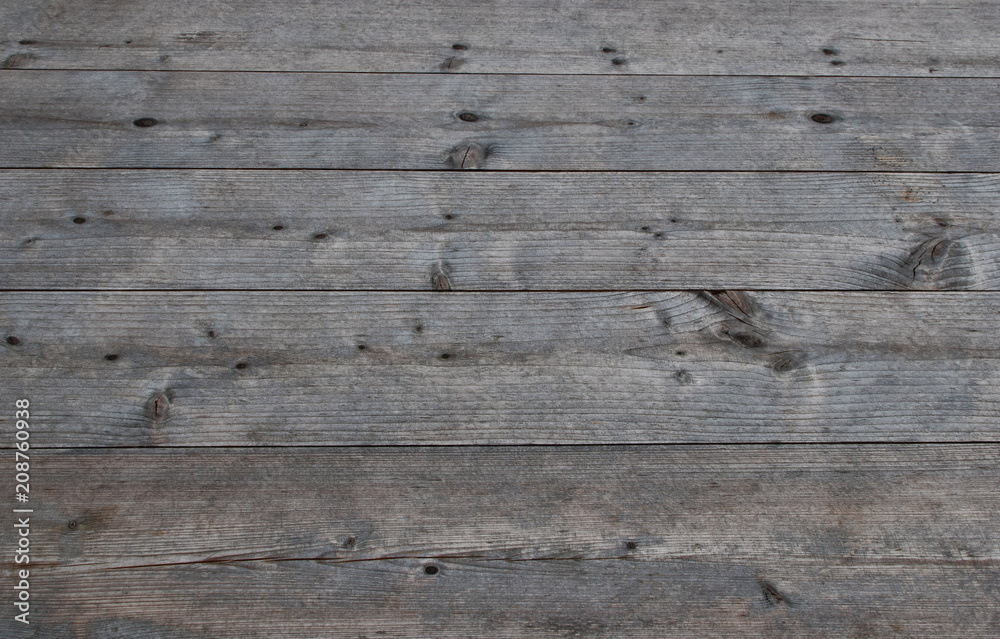 Grey natural weathered table of wooden planks as textured background. Grey natural weathered table of wooden planks as textured background.