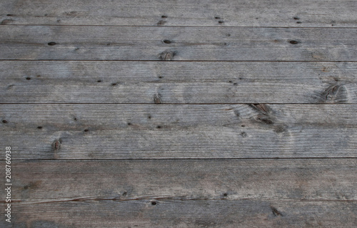 Grey natural weathered table of wooden planks as textured background.