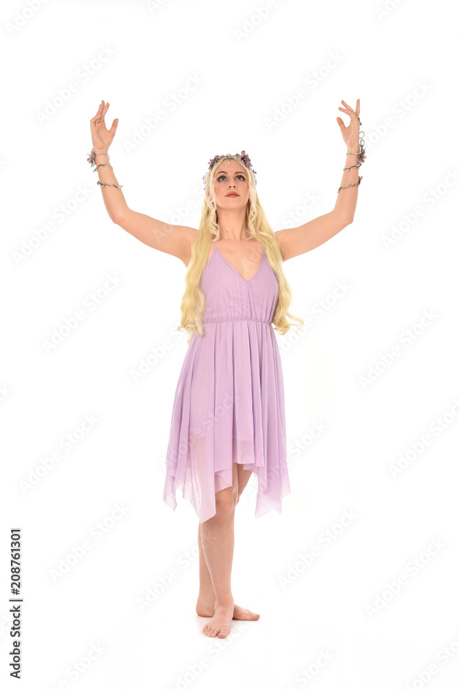 full length portrait of pretty blonde girl wearing purple fairy dress. standing pose, isolated on white studio background. full length portrait of pretty blonde girl wearing purple fairy dress. standing pose, isolated on white studio background.