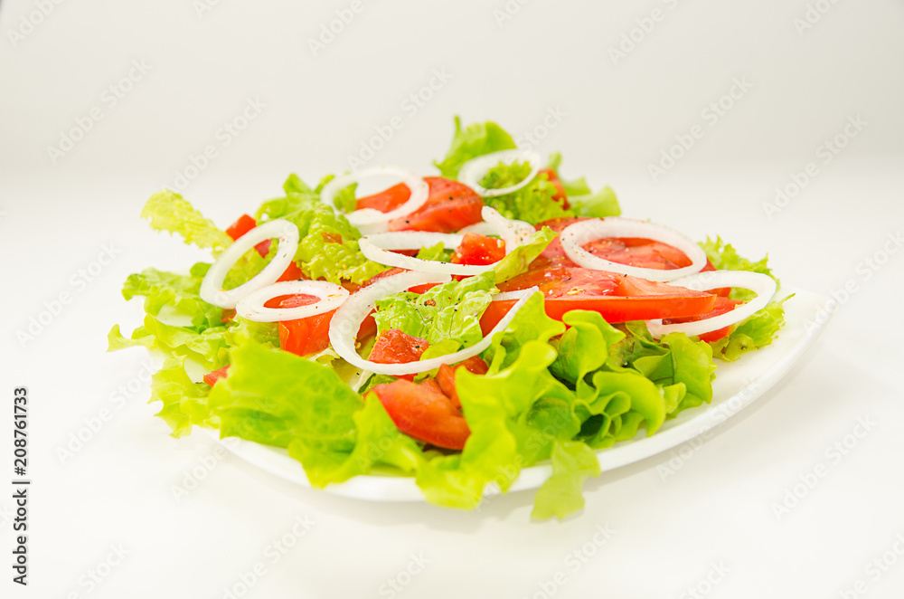 Salad on a square plate on a white background Salad on a square plate on a white background