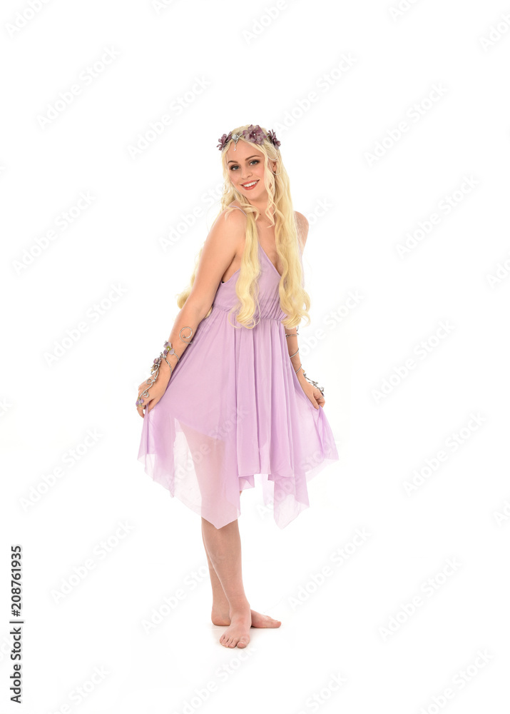 full length portrait of pretty blonde girl wearing purple fairy dress. standing pose, isolated on white studio background. full length portrait of pretty blonde girl wearing purple fairy dress. standing pose, isolated on white studio background.
