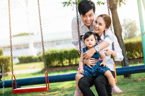 Asian family portrait with happy people smiling at the park ,Lifestyle and Holiday Concept. 