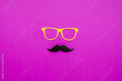 top view of gentleman face made of cardboard eyeglasses and mustache on pink surface
