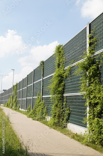 Sidewalk covered with acoustic panels to protect against noise caused by cars photo