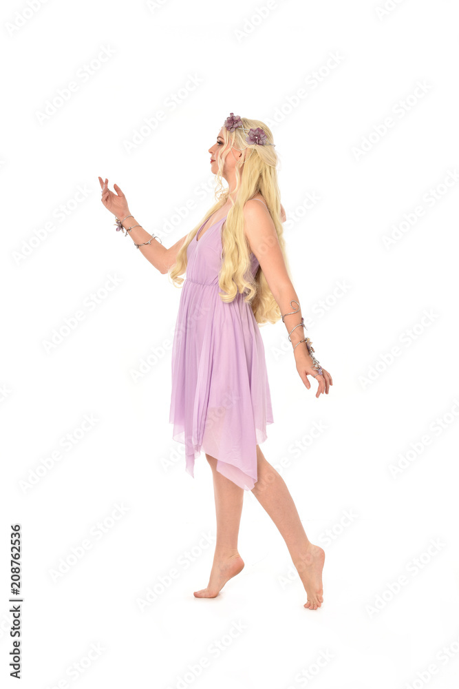 full length portrait of pretty blonde girl wearing purple fairy dress. standing pose, isolated on white studio background. full length portrait of pretty blonde girl wearing purple fairy dress. standing pose, isolated on white studio background.