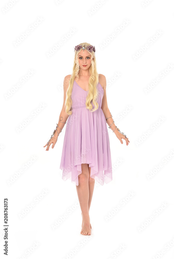 full length portrait of pretty blonde girl wearing purple fairy dress. standing pose, isolated on white studio background. full length portrait of pretty blonde girl wearing purple fairy dress. standing pose, isolated on white studio background.