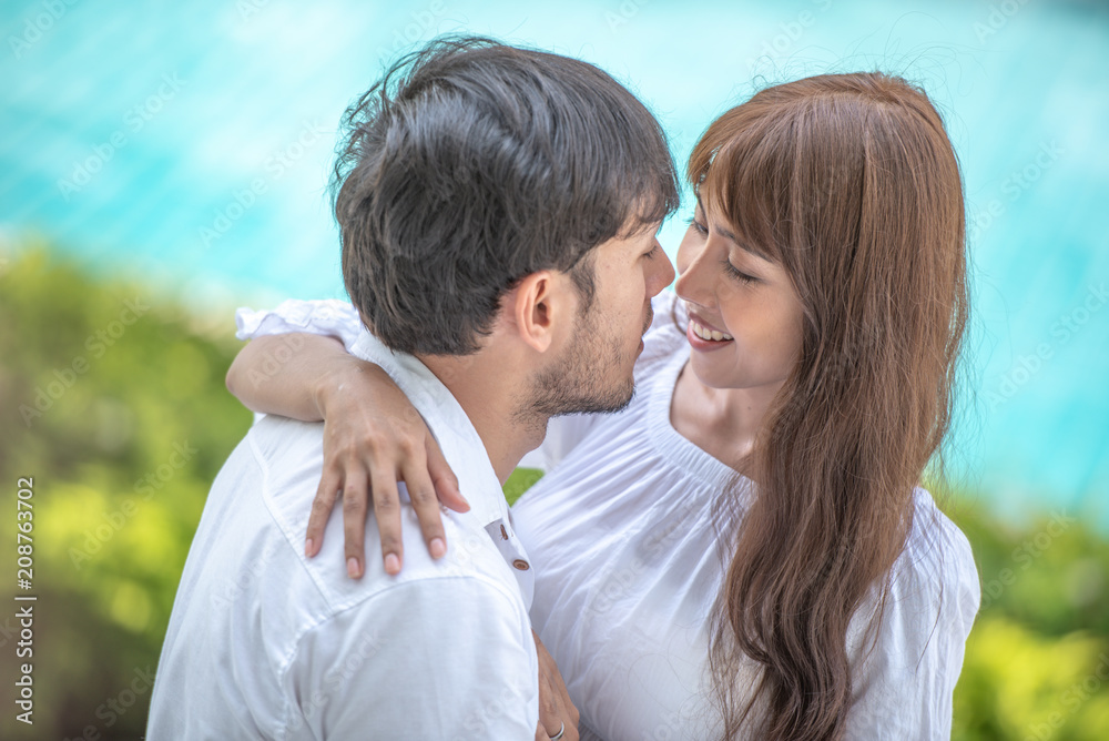 Happy Asian young couple holding hand , looking and laughing each other with happiness together, close up, romantic couple spending time concept. Happy Asian young couple holding hand , looking and laughing each other with happiness together, close up, romantic couple spending time concept.