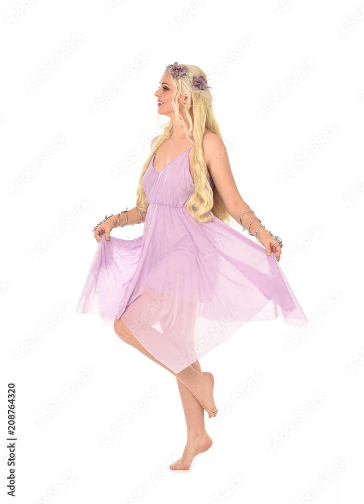 full length portrait of pretty blonde girl wearing purple fairy dress. standing pose, isolated on white studio background. full length portrait of pretty blonde girl wearing purple fairy dress. standing pose, isolated on white studio background.