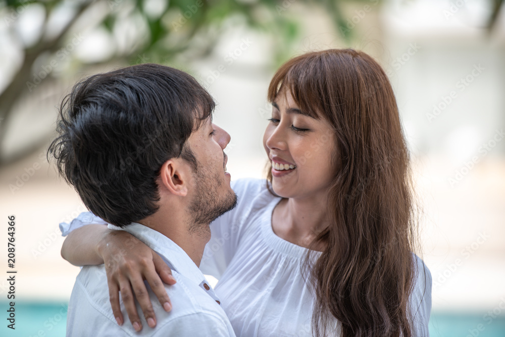 young couple holding hand , looking and laughing each other young couple holding hand , looking and laughing each other