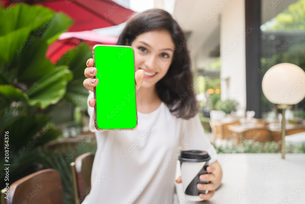 young woman showing modern gold smartphone with green screen for replacement