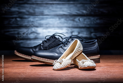 close-up shot of leather father and daughter shoes on wooden surface, Happy fathers day concept