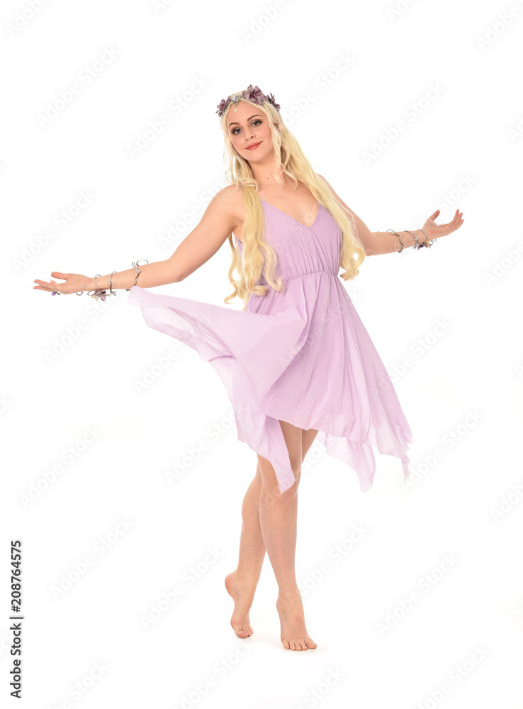 full length portrait of pretty blonde girl wearing purple fairy dress. standing pose, isolated on white studio background. full length portrait of pretty blonde girl wearing purple fairy dress. standing pose, isolated on white studio background.