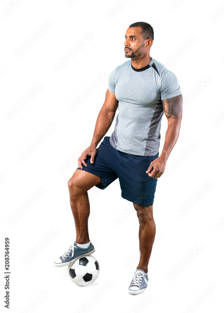 Strong football player with soccer ball on isolated white background Strong football player with soccer ball on isolated white background