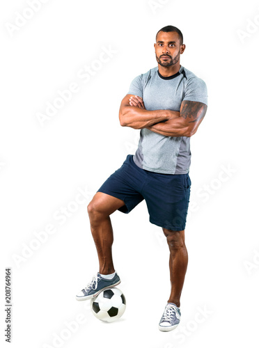 Strong football player with his arms crossed on isolated white background © luismolinero