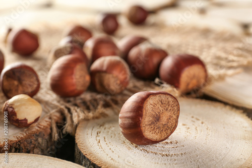 Tasty hazelnuts on wooden stumps background