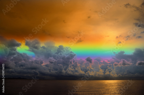 sunset sky rainbow over silhouette orange cloud on the sea