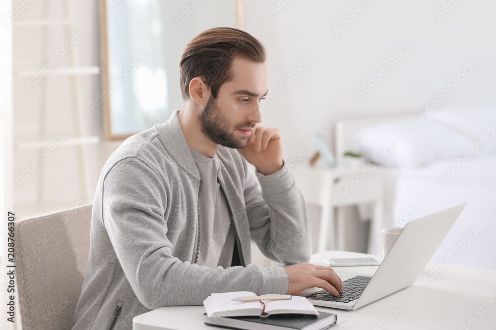Male freelancer working with laptop in home office Male freelancer working with laptop in home office