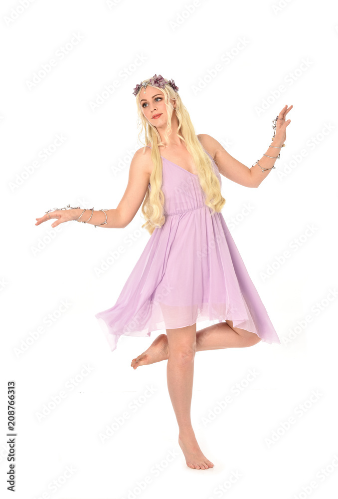 full length portrait of pretty blonde girl wearing purple fairy dress. standing pose, isolated on white studio background. full length portrait of pretty blonde girl wearing purple fairy dress. standing pose, isolated on white studio background.