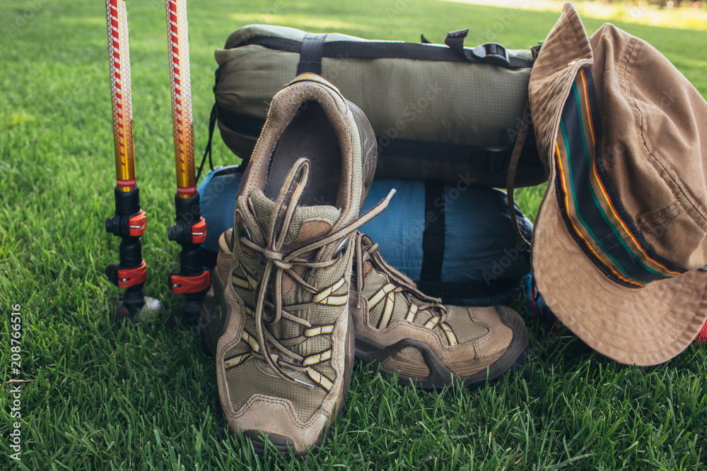 trekking poles, boots, , sleeping bag , hat and other equipment backpacker,  on the green grass close-up Stock Photo | Adobe Stock