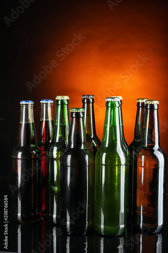 Fresh beer in glass bottles on dark background