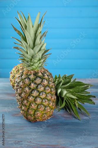 Tasty pineapples on wooden table