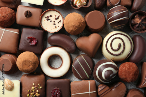 Different tasty chocolate candies on table, top view