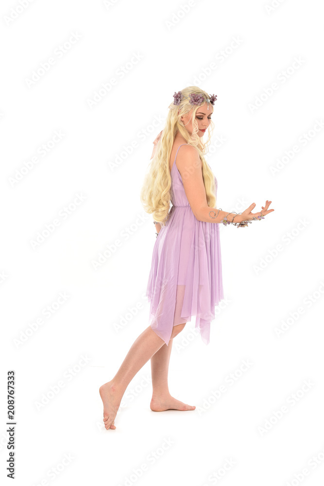full length portrait of pretty blonde girl wearing purple fairy dress. standing pose, isolated on white studio background. full length portrait of pretty blonde girl wearing purple fairy dress. standing pose, isolated on white studio background.