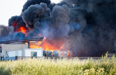 Landfill fire with huge black cloud of smoke