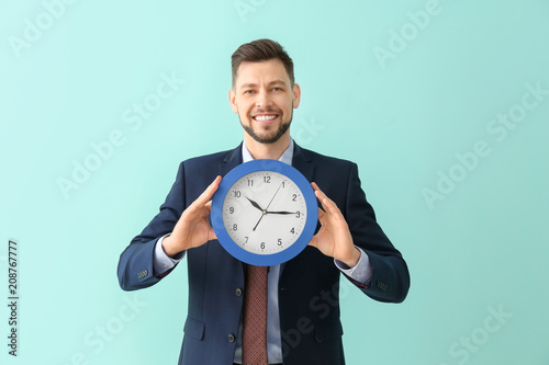 Businessman with clock on c...